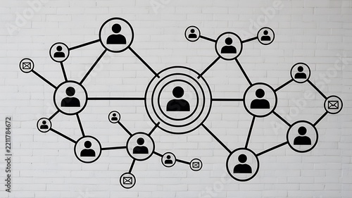 Social network concept with connected icons of people and communication symbols on a white brick wall