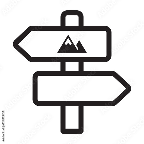 Black and white wooden directional sign post pointing toward mountain hiking trails.
