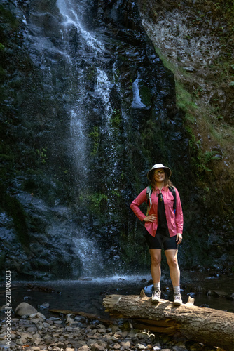 Smiling Female Hiker in a Sun Hat at the Base of Double Falls