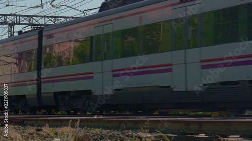 Commuter passenger train passing on railway tracks