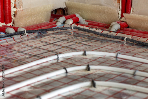 New house with radiant floor heating tubing fixed in place before concrete pour. Sustainable building technology, warmth and indoor comfort concept.