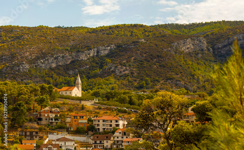 Historic Church and Village Beneath Rocky Hills in a Mediterranean Landscape