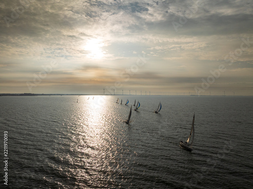 Sailboats Leaving Urk Harbor at Sunrise in Backlight