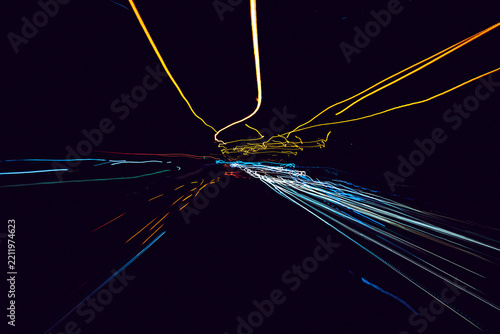 Abstract light trails creating dynamic patterns on dark background