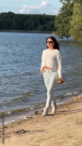 Young Woman In White Sweater Walking On Sandy Beach Video