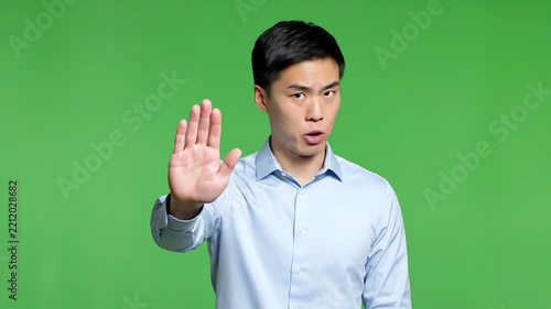 Young Asian Man Expresses Shock and Surprise on Green Screen