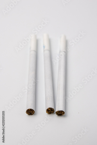 Three White Cigarettes With Tobacco Ends