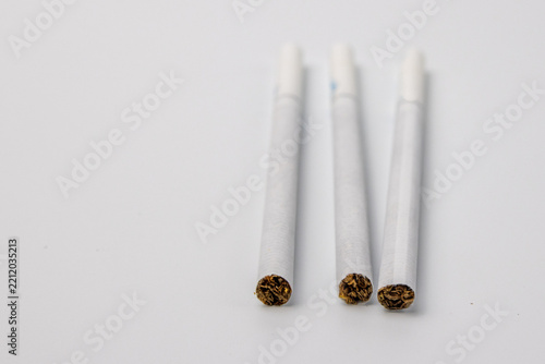 Three White Cigarettes With Tobacco Ends
