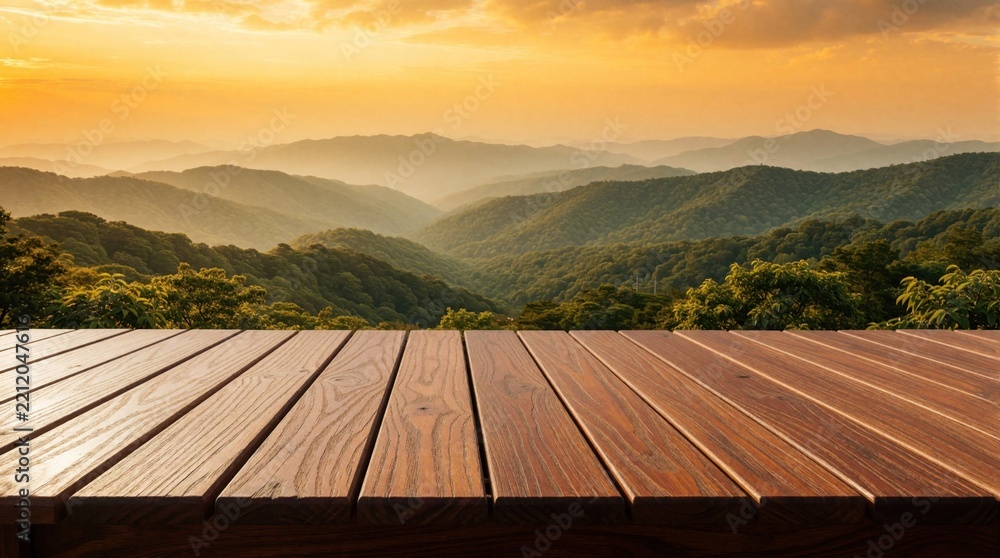 Obraz premium Empty wooden deck table with brown texture in foreground. View of green mountain range, forest under golden sunset sky. Scenic landscape with misty hills. Mockup surface for product display in nature