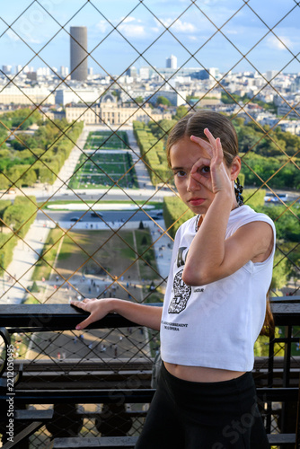 Young girl poses playfully near a city view