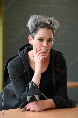 Thoughtful woman with short hairstyle looking at camera