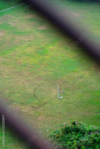 Basketball hoops without net is standing alone in the field in Malaysia