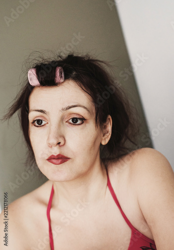 portrait of a middle‑aged brunette woman at domestic entourage.