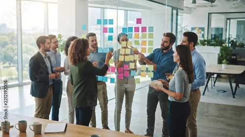 Team discussing project with sticky notes on wall