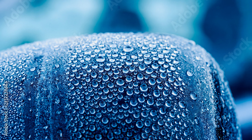 Macro view of condensation water droplets on a cold blue surface