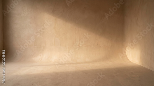 Studio backdrop displays rough beige textures illuminated by soft warm directional lighting.