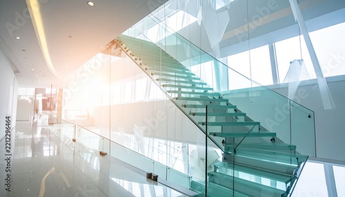 Modern minimalist staircase with glass banister in a brightly lit office atrium glass railing modern interior