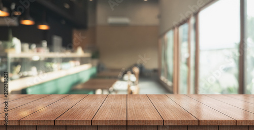 Empty wooden table top with lights bokeh on blur restaurant background.	
