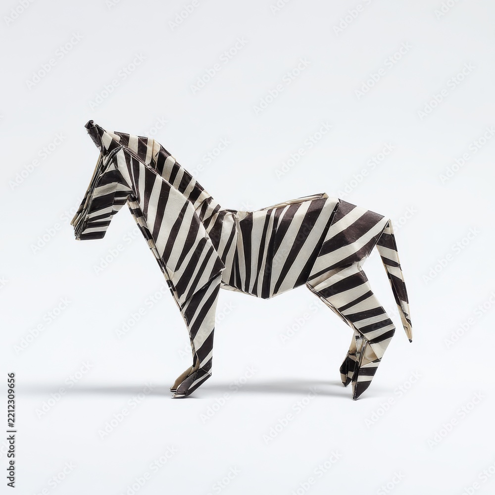 Obraz premium Origami Zebra Paper Figure With Black And White Stripes On A Clean Plain White Background