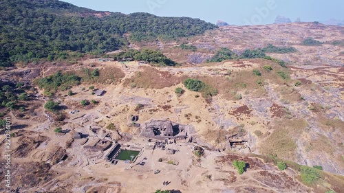 Drone view of ancient Harishchandreshwar temple atop historic Harishchandragad hill fort in Maharashtra