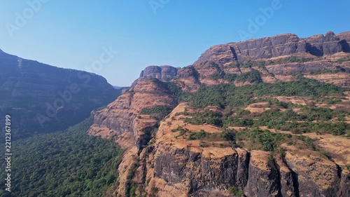 Majestic aerial view of rugged mountain landscapes stretching endlessly beneath clear horizon skies