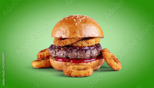 Gourmet beef burger accompanied by crispy onion rings for fast food branding, restaurant promotions and menu design.