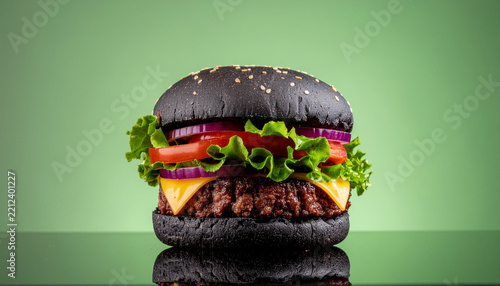 Modern charcoal bun burger with premium beef and fresh vegetables, designed for restaurant branding and luxury food campaigns.