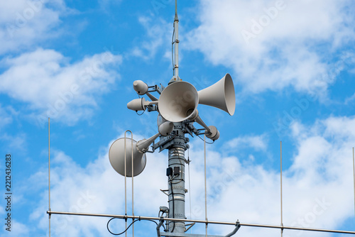 Municipal disaster prevention radio speaker tower against a blue sky