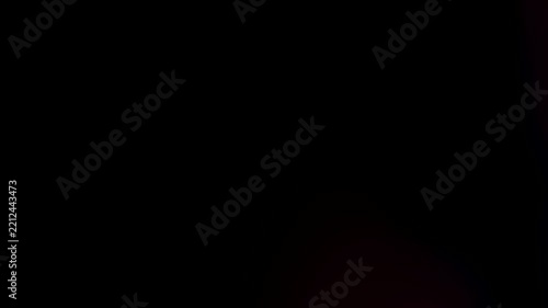 Subtle dark gradient texture with soft purple lens light leak on black background
