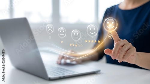 Business professional using a laptop to select a positive smiley face rating on a digital customer feedback interface representing high service quality and user experience technology