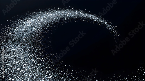 Sparkling silver glitter swirl on dark background for elegant holiday celebration design.