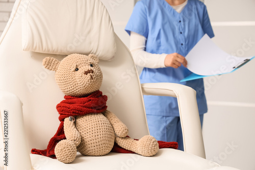 Pediatric healthcare and child wellness, sick teddy bear with thermometer in ...