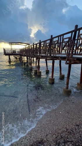Weathered Wooden Pier Reaching into the Clear Blue Ionian Sea at Dawn