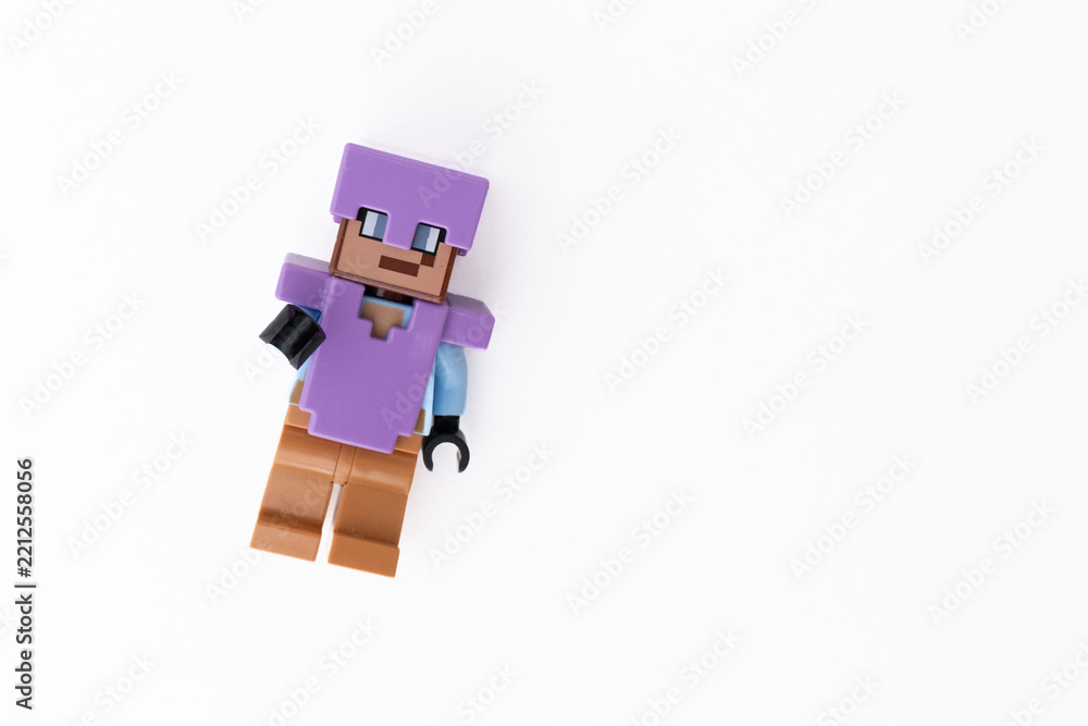Naklejka premium Lego Minecraft Steve mini-figure in purple clothes and helmet, shot isolated on a white background with room for copy space. Bradford, UK Oct 2 2026