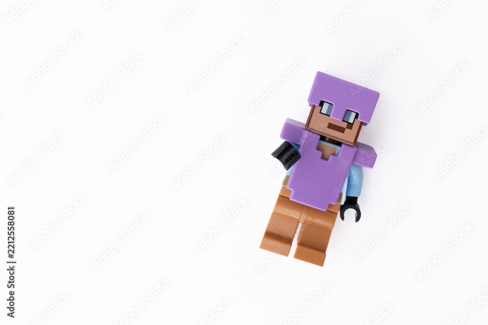 Naklejka premium Lego Minecraft Steve mini-figure in purple clothes and helmet, shot isolated on a white background with room for copy space. Bradford, UK Oct 2 2026