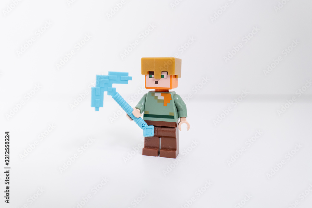 Naklejka premium Lego Minecraft Steve mini-figure holding a blue axe, shot isolated on a white backgound. Bradford, UK Oct 2 2026