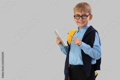 Digital childhood and edtech, schoolboy with tablet computer and backpack rea...