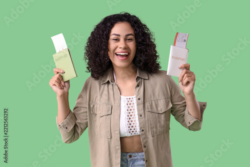 Travel planning and vacation excitement, happy woman holding passports and fl...