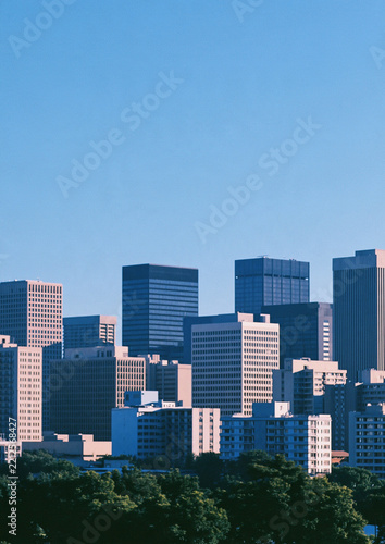 Blue City Skyline - Modern Buildings and Clear Sky - A dense cluster of high rise offices stands beneath a spacious blue sky, ideal for posters, covers, business themes, and urban backgrounds
