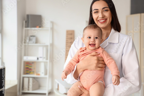 Pediatric healthcare and child wellness, female pediatrician holding a happy ...