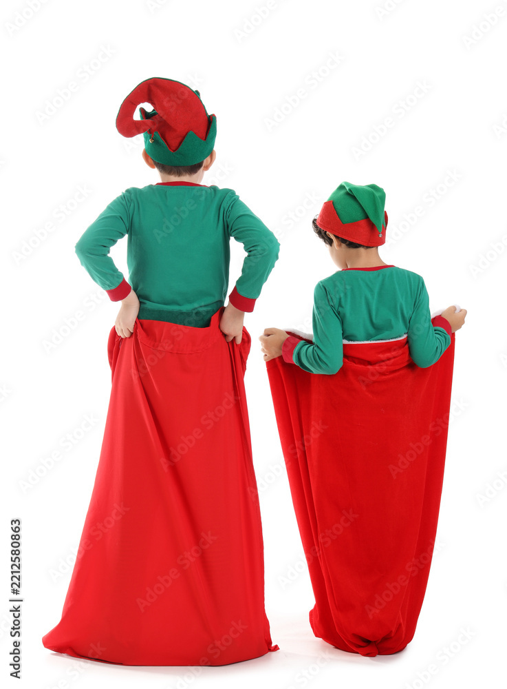 Obraz premium Cute little children in elves costumes with Santa bags isolated on white background, back view