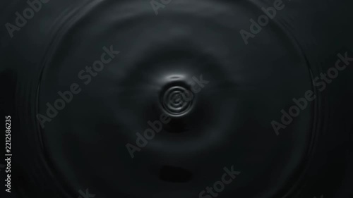 Dark Abstract Background with Concentric Ripples and a Central Vortex