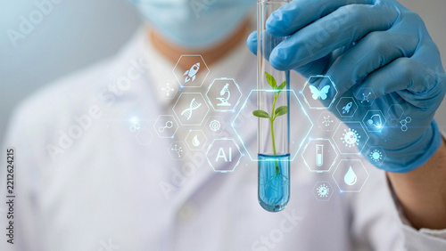 Scientist holding test tube with plant seedling during biotechnology research with glowing digital icons
