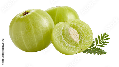 Fresh whole and sliced Indian gooseberry amla fruits with green pinnate leaves