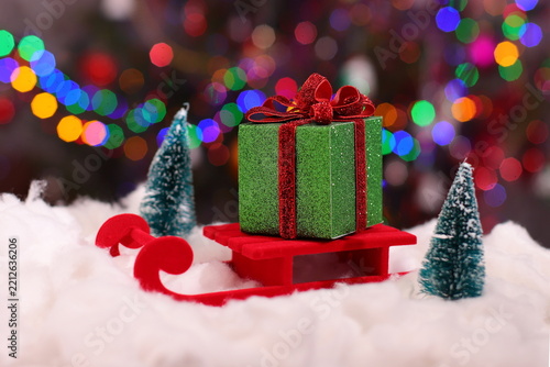 Christmas green present box, holiday package on snow