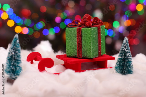 Christmas green present box, holiday package on snow