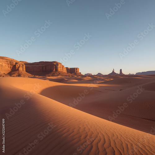 Vast Red Desert Landscape Featuring Sculpted Sand Dunes and Rugged Rock Formations Beneath a Clear Blue Sky