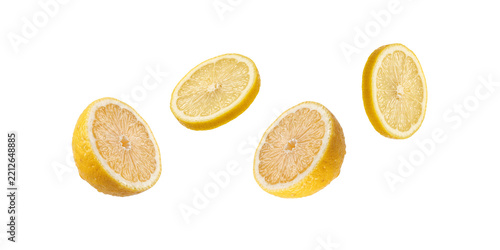 Fresh lemon halves and slices floating against a solid transparent background