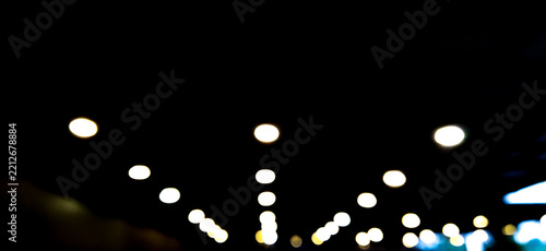 Fotografie Abstract blurred bokeh lights on dark background, ideal for wallpaper, overlay, copy space