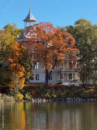 Colorful Autumn Trees and villa Reflected in Still Water in helsinki